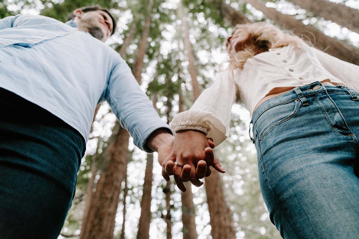 holding hands shalow focus photo of man and woman holding each others hands person